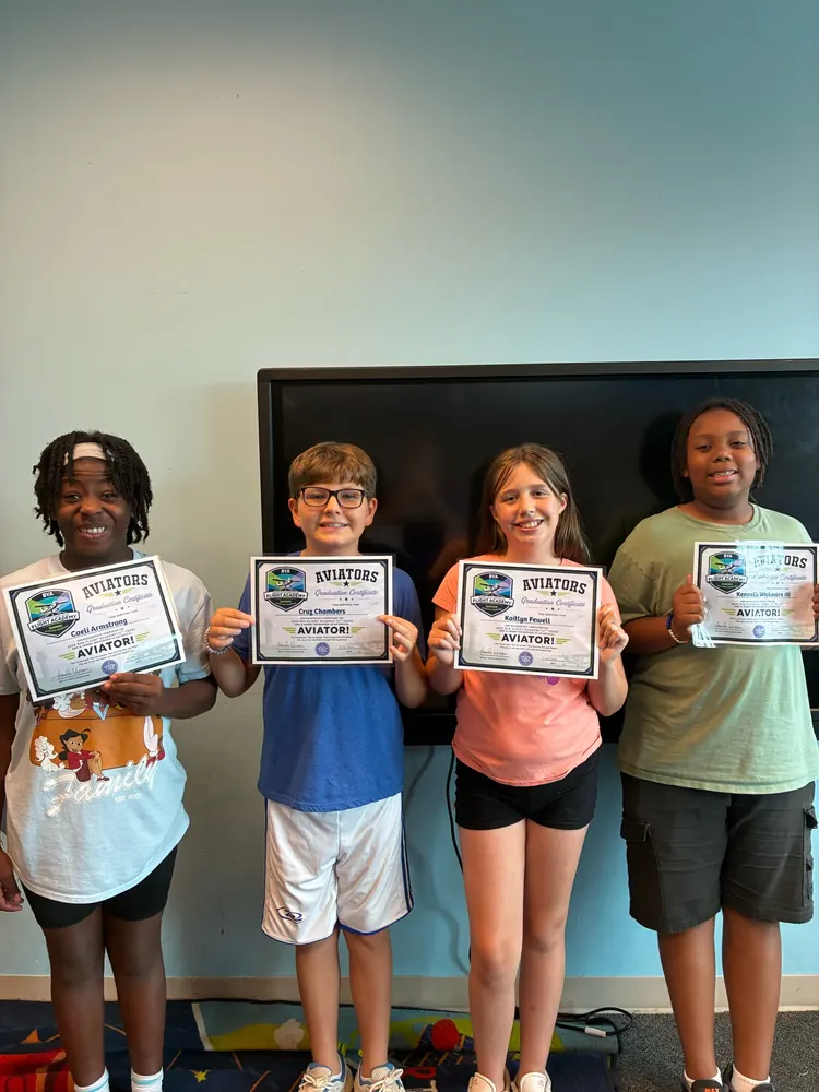 Kids holding BYA Flight Academy certificates at summer camp in Bryant, AR